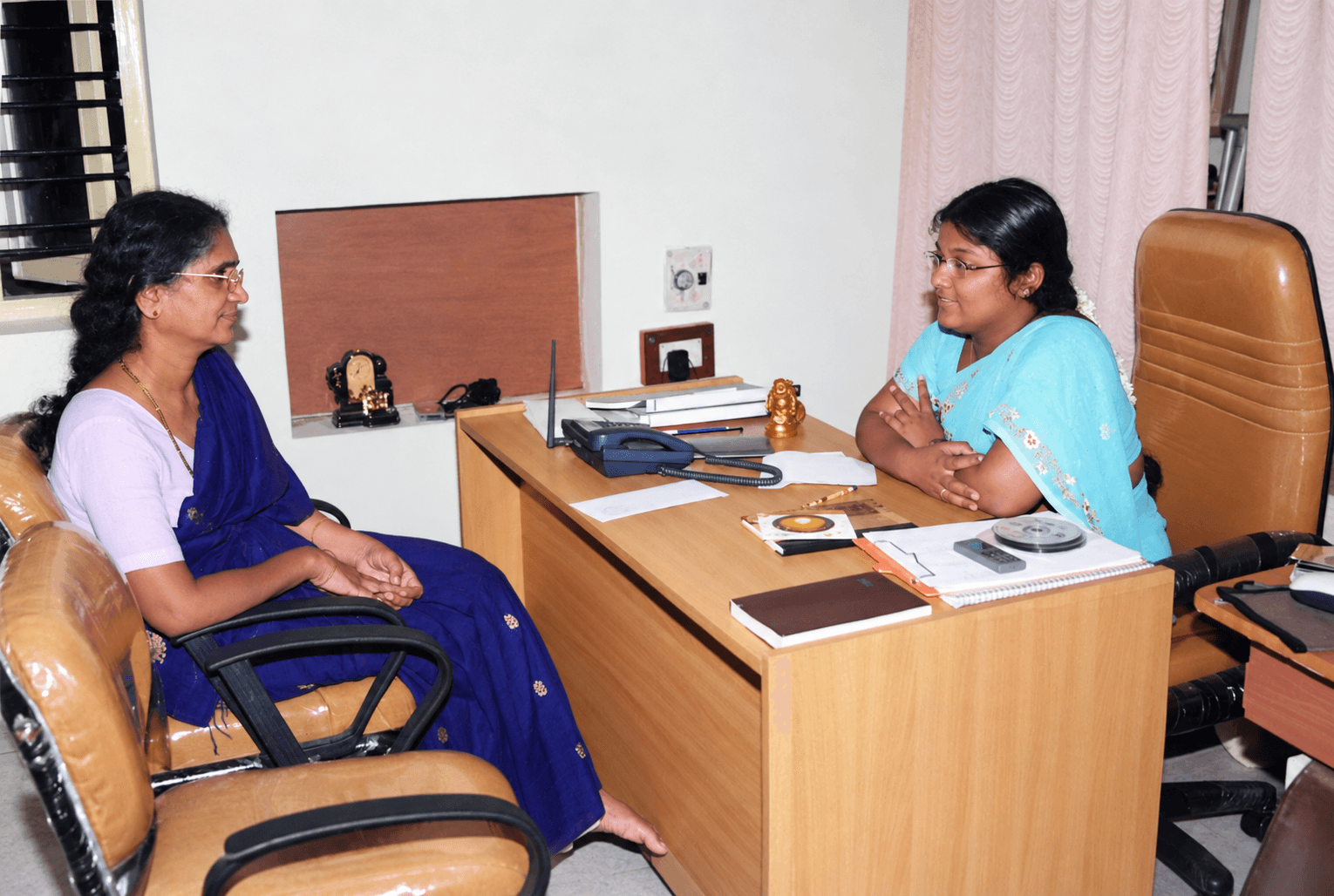 Pushpa Valli in conversation with a visitor at her office during the Prapoorna Children’s Club years.