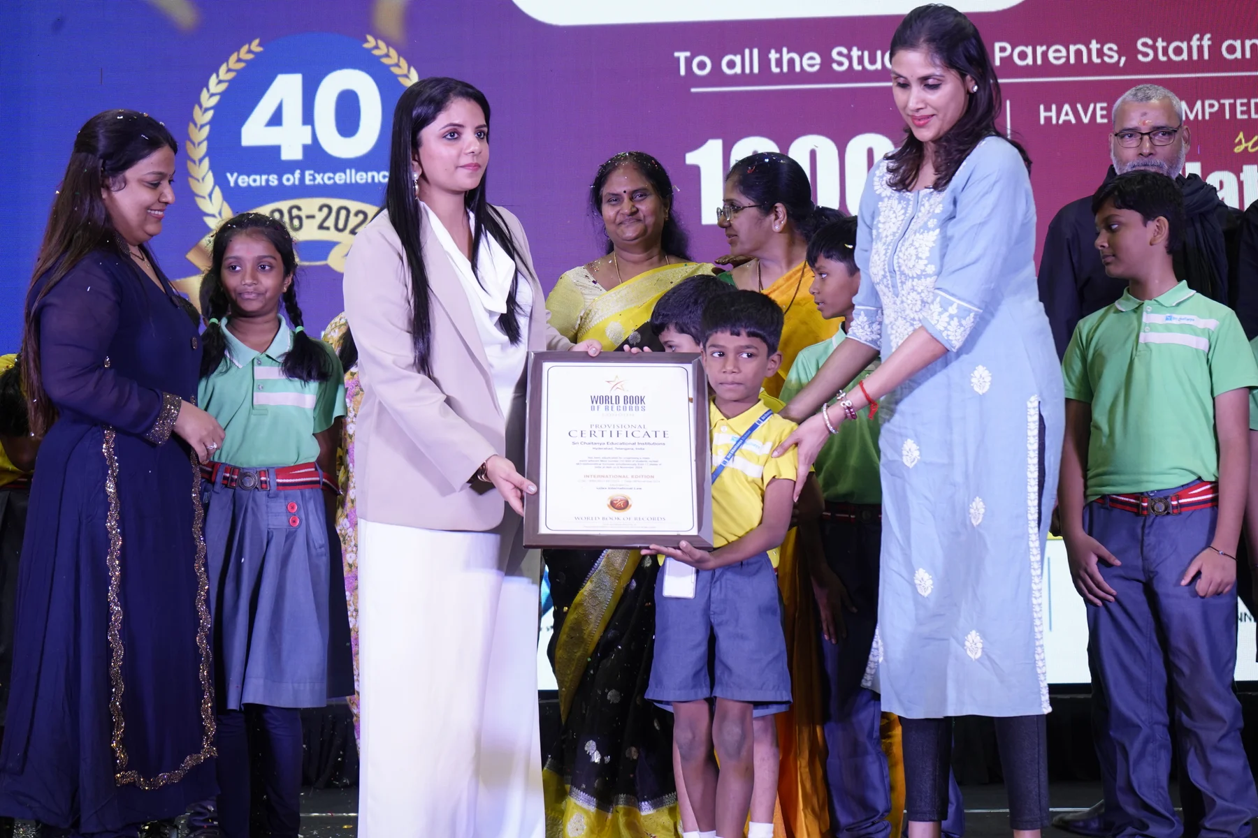 Pushpa Valli, students and educators with the World Book of Records certificate for reciting 663 mathematical formulae in November 2024.